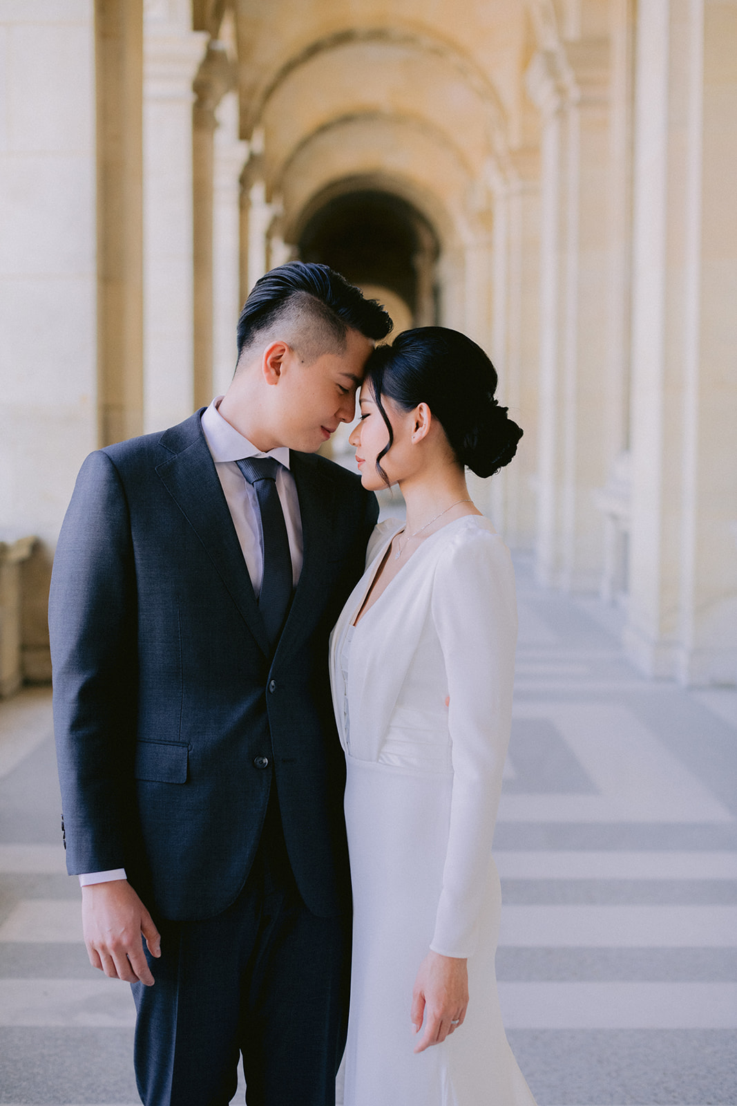  lovers are walking at the louvre museum in paris.